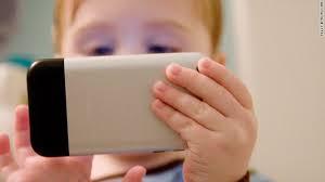 young boy on smartphone in restaurant