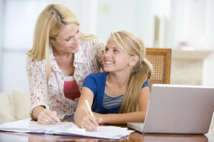 Parent going over a check-list of computer rules before child uses computer