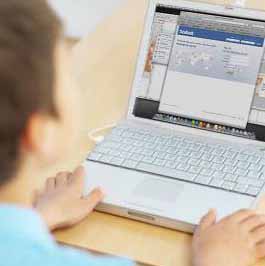 Boy on Facebook using laptop