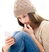 teen looking at smartphone has sad expression